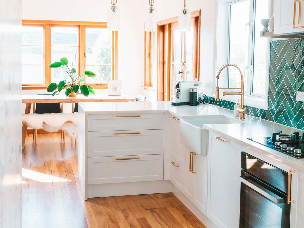 Spotless kitchen with clean cabinetry and timber floors